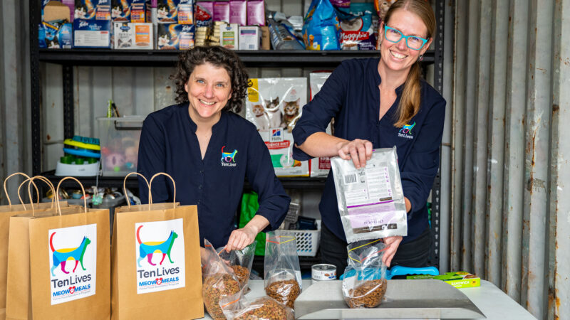 Ten Lives team members Kate and Alyssa prepare the “Meow Meals” food assistance packs.